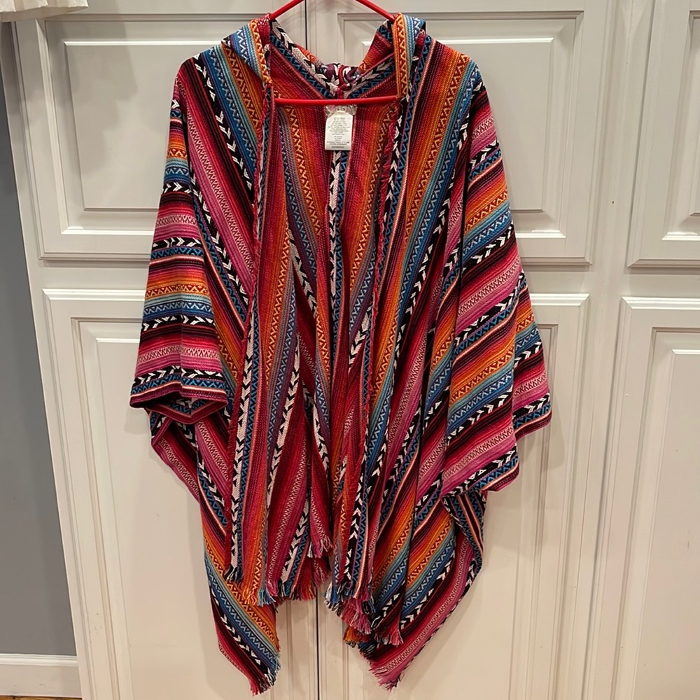 Free People hooded poncho. Vibrant colors. Fringed edges. Long length.